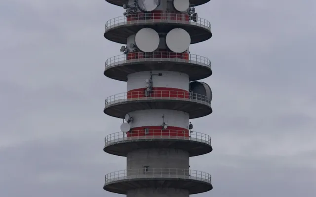Telecommunications tower carrying microwave and radio antennas